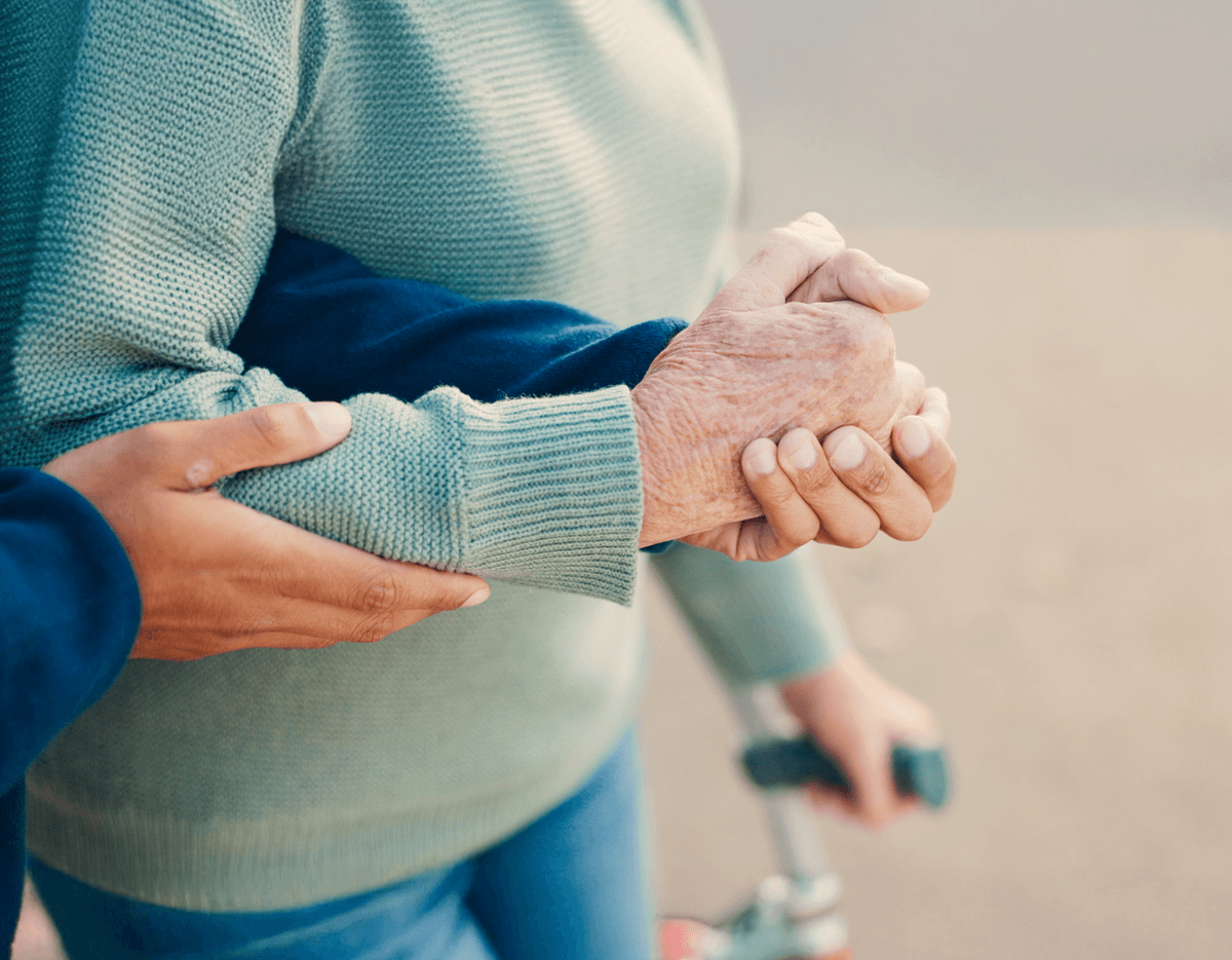 Man helping grandmother by holding her hand