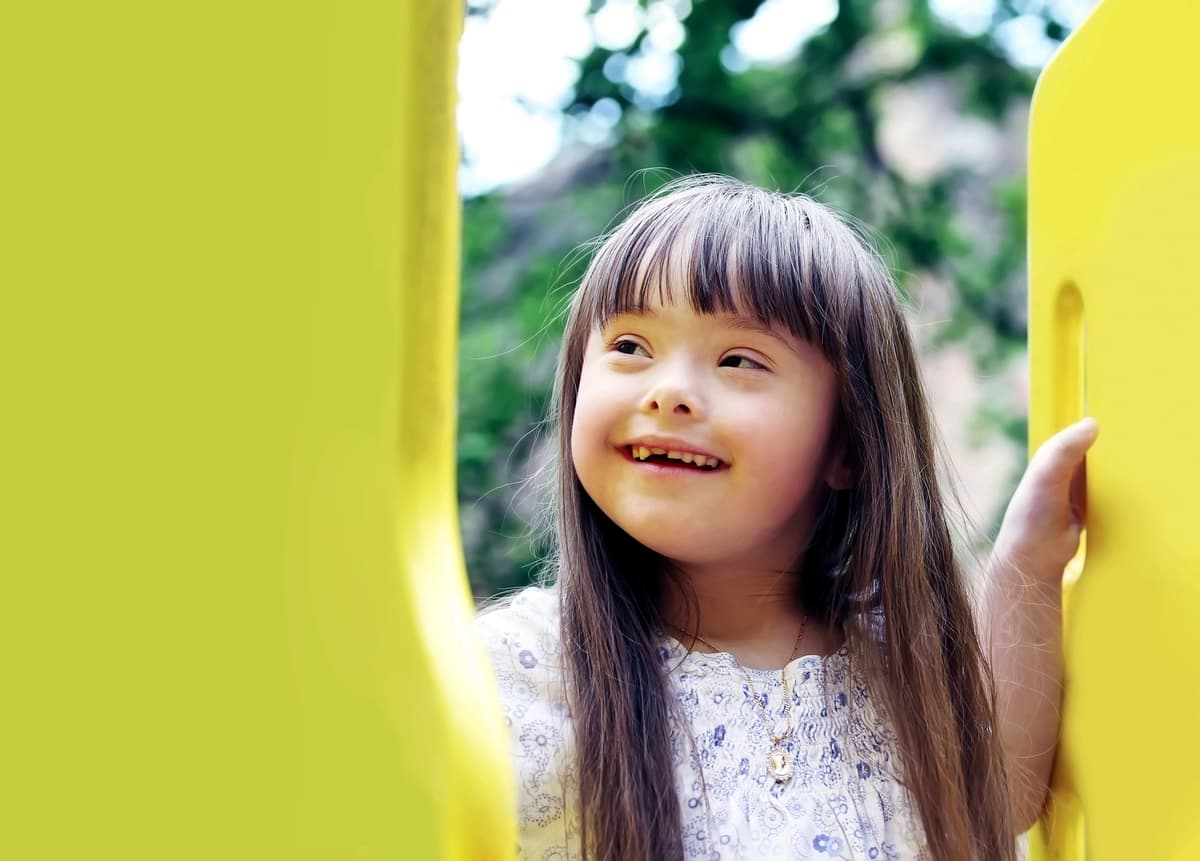 Smiling young girl playing outdoors.